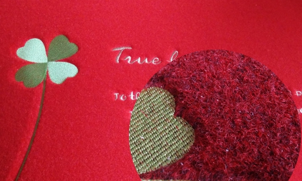 Embroidered door mat surface